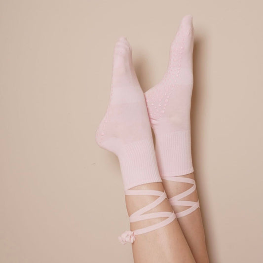 Pink socks with lace details on a beige background